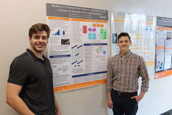 Dayton Kizzire and Alex Greenhalgh standing in front of research poster